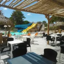 Outdoor pool with water slides and patio seating